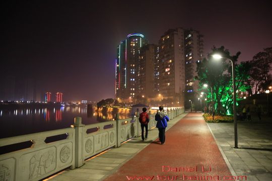 The walkway along the river bank is partially made of synthetic tracks 