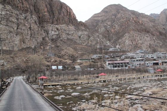 A bridge is built to connect the main road to the village. Under the bridge is the famous Pearl lake.