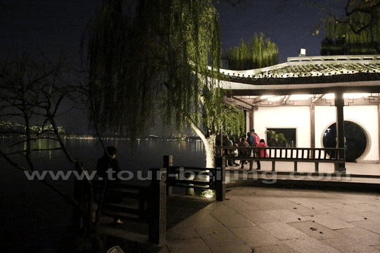 A lit pavilion by the lake