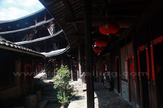 Between the four storeys outer ring and the one storey building in the second ring.