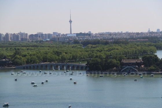 Boats are dotted on the Kunming Lake against the backdrop of the CCTV Tower.