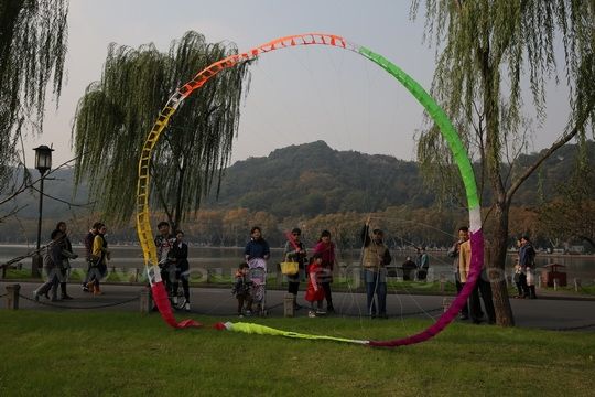 Flying a paper ring kite.