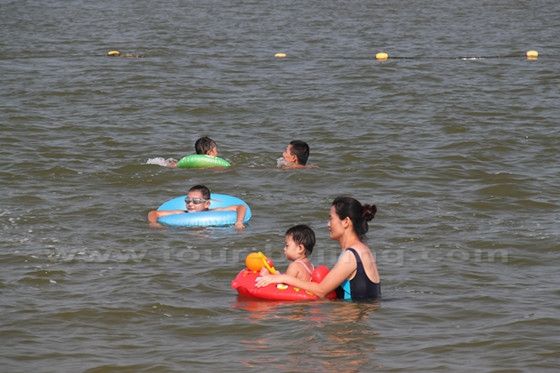 Kids are happy playing on the sea.