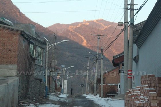 Passing through Dazhenyu Great Wall with a distant view of the Great Wall snaking on the ridges.