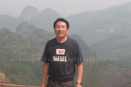 Posed on the sightseeing platform witht the double-breast peaks as the background.