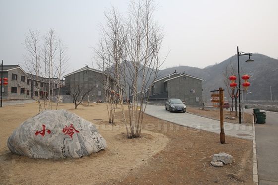 Rows and rows of newly built grey brick townshouses are neatly arrayed along the Simatai Village.