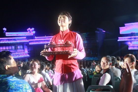 Some actors turned service boys and girs come to us offering Dahongpao tea for people to taste at end of the show.