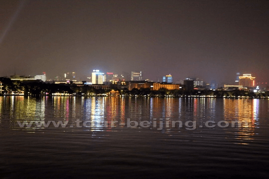 The buildings on the east side of the lake with their reflections on the water.