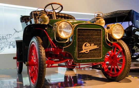 The old time care has an exaggerated headlights and thin tires.