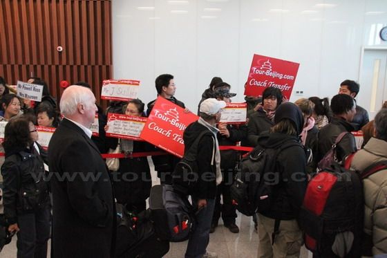The passengers are thronging past the tour guides