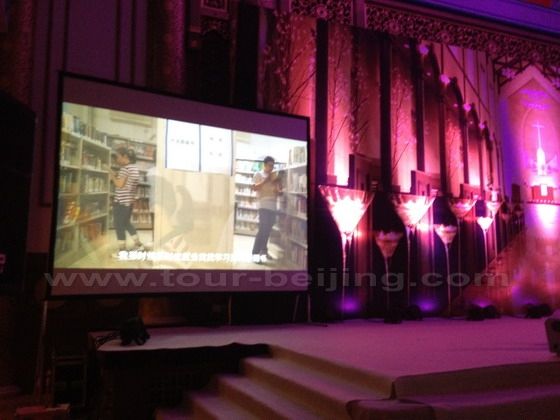 The projection screen is putting on a VCR about the bride 