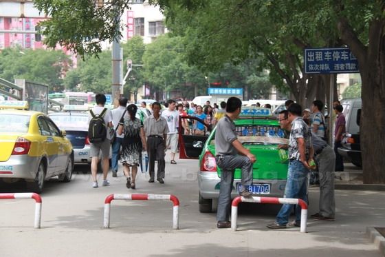 The taxi stand is northwest to the square in front of the main terminal building