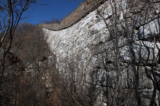 The wall was built of massive stone and slabs 