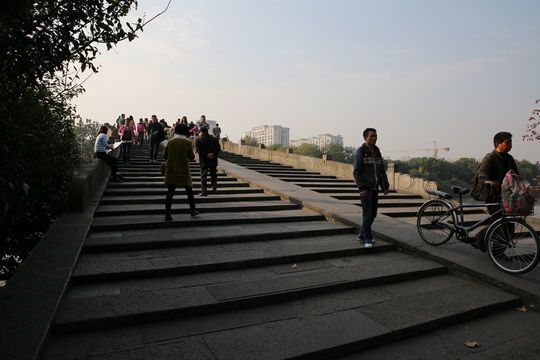 Walk across Gongchen Bridge that spans the Grand Canal