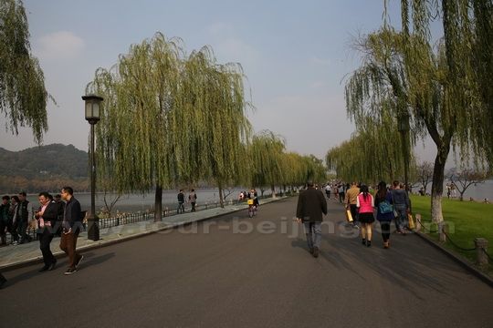 Walk on the Baidi Causeway lined with waving willow trees.