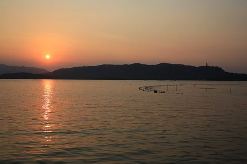  The red and orange colors of the sunset mirrored on the lake