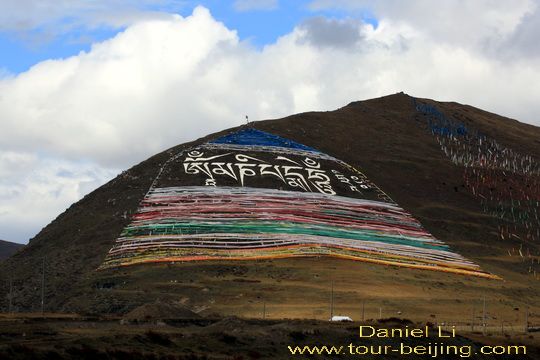 a huge mantra painted on the slope 