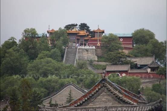 Another temple is nestled on a top cirecled by trees