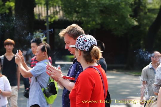 Burning a joss stick and praying