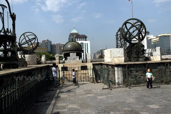 view these instruments with a backdrop of modern buildings nearby